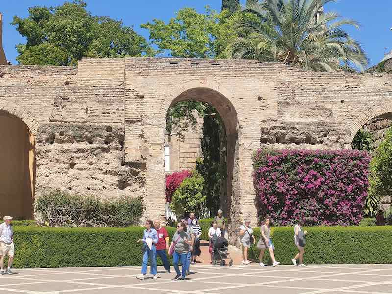Walking through the Arabic Arches into Seville Alcazar